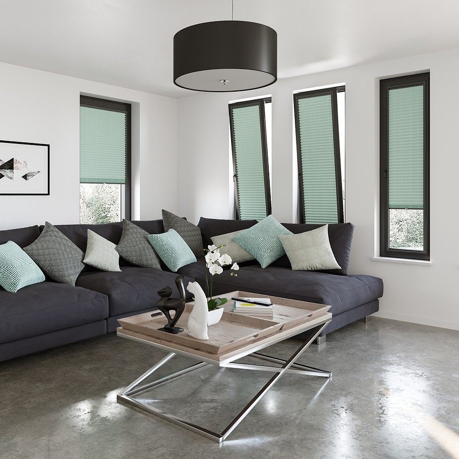 Green pleated blinds fitted to tilt-and-turn windows in a living room